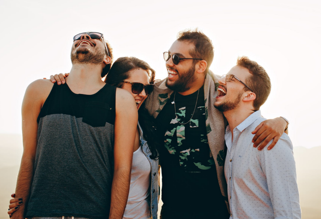 group of friends laughing, optimism