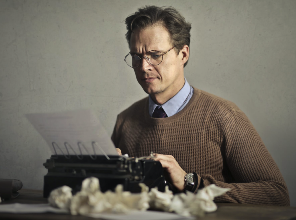 man writing at a typewriter, fiction filler, bad writing, purple prose
