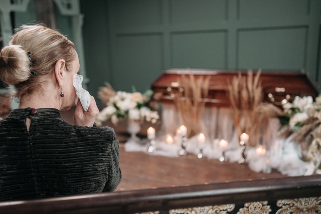 woman grieving at a funeral, weakness, trauma