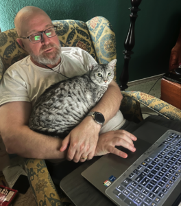 man at computer with cat in lap, thankful